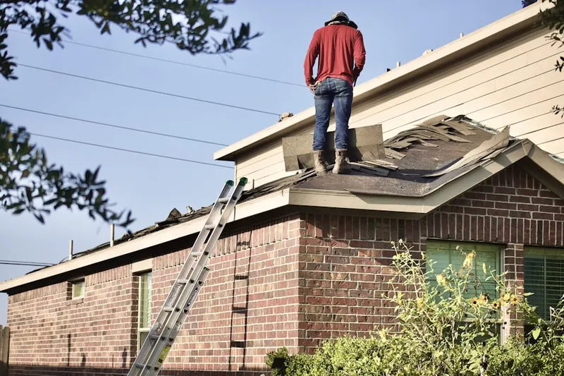 Professional roofer working on a residential roof in Highlands of Monroe